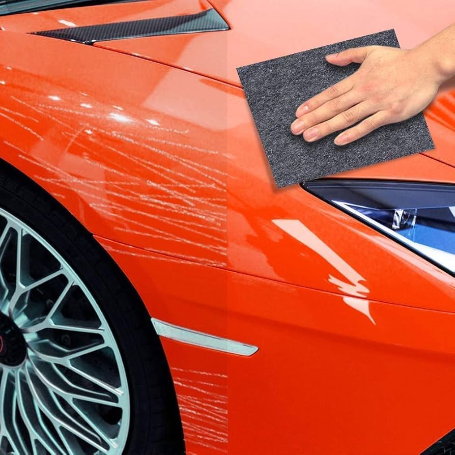Polishing red sports car.